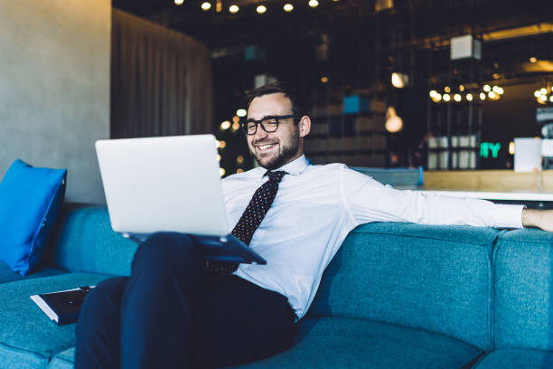 aweber vs mailchimp: photo of entrepreneur sitting on couch happy with their customers service experience.