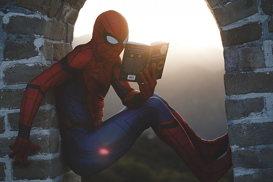 What Is Seo Keyword Research: Photo of spider man reading on a building top